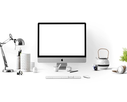 A workspace with a desk lamp positioned properly to avoid shadows